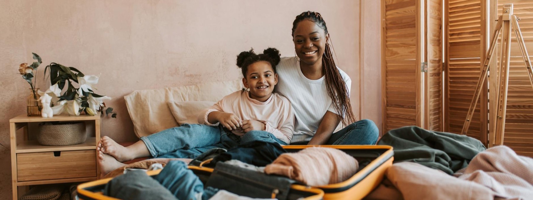 Smiling parent and child packing for travel therapy
